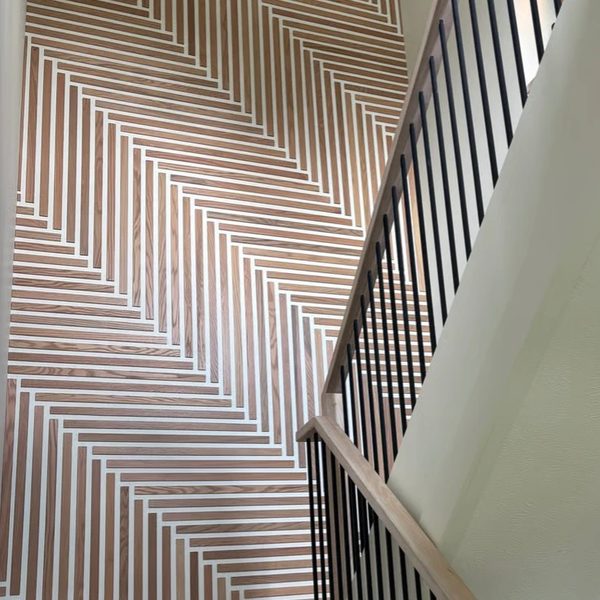 Wood slat herringbone accent wall on a staircase